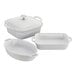 Three white ceramic baking dishes with lids.