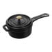 A black Staub enameled cast iron sauce pan with a lid and handle.