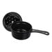 A close-up of a black Staub enameled cast iron saucepan with lid.
