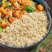 A bowl of Lotus Foods long grain white basmati rice with chopsticks on a table.