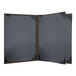 A black menu cover with brown leather corners.