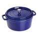 A dark blue Staub enameled cast iron pot with a lid.