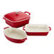A group of red and white Staub baking dishes, including oval and rectangular dishes.