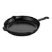 A black Staub enameled cast iron skillet with a handle.