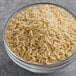 A glass bowl filled with long grain brown jasmine rice.