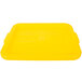 A yellow Vollrath Traex food storage box lid with a recessed circle in the middle.