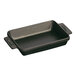 A black rectangular Staub enameled cast iron pan with handles.
