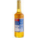 A Torani Passion Fruit syrup bottle with a blue label.
