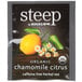 A package of Steep By Bigelow organic chamomile citrus tea bags on a table with a lemon and flowers.