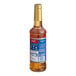 A close up of a Torani Pumpkin Pie flavoring syrup bottle with a blue label.