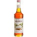 A Monin Premium Cinnamon Flavoring Syrup 750 mL bottle.