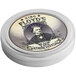 A round silver container of King Floyd's Black Lava Rimming Salt with a picture of a man wearing a crown.