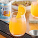 A glass of Polar Diet Orange Dry with a slice of orange on the rim.