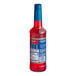 A Torani plastic bottle of red liquid syrup with a label on it.
