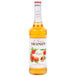 A Monin Peach Syrup 750 mL bottle.