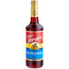 A Torani Red Raspberry flavoring syrup bottle with a red label.