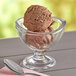 A bowl of Oringer chocolate ice cream with a spoon in it.