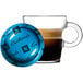 A glass cup of brown Nespresso Guatemala coffee on a saucer.