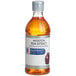 A close up of a McCormick Culinary Imitation Rum Extract bottle full of amber liquid with a label on it.