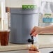 A person pouring Toddy Blend cold brew coffee into a cup.