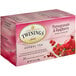 A pink box of Twinings Pomegranate & Raspberry Herbal Tea with a close-up of fruit on the front.