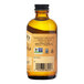 A close up of a Nielsen-Massey Pure Orange Extract bottle. The label reads "Nielsen-Massey 4 fl. oz. Pure Orange Extract."