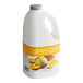 A white Torani jug of mango fruit smoothie mix with a yellow label.