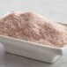 A white container filled with Regal Fine Grain Pink Himalayan Salt.