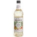 A close up of a Monin bottle of white peach syrup.