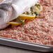 A fish with lemon slices and herbs on top of a tray of Regal Coarse Grain Pink Himalayan Salt.