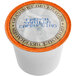 A Caffe de Aroma French Vanilla Cappuccino single serve cup with orange and blue text.