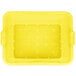 A yellow plastic Vollrath Color-Mate drain box with holes.