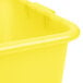 A close-up of a yellow plastic container with a white lid.