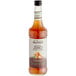 A bottle of Monin Zero Calorie Caramel Flavoring Syrup with a white label.
