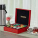 A Twinings wooden tea chest on a table with a tray of tea and coffee.