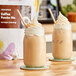 Two mason jars filled with Bossen coffee powder on a wooden table.