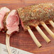 A rack of meat with Regal Ground Thyme on a wooden surface.