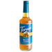 A Torani Sugar-Free Belgian Cookie flavoring syrup bottle with a blue label filled with brown liquid.