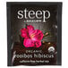 A black package of Steep By Bigelow Organic Rooibos Hibiscus Tea Bags on a table in an organic food store.