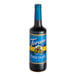 A Torani Sugar-Free Chocolate Flavoring Syrup 750 mL glass bottle with a blue label containing liquid.