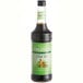A Monin Chai Tea concentrate bottle with a green label.