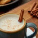 A mug of milk with Regal cinnamon sticks.