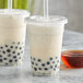 Two cups of bubble tea with Bossen caramel syrup and black balls.