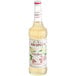 A bottle of Monin Elderflower Flavoring Syrup with a label.