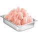 A metal container filled with blood orange soft serve mix.