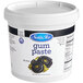 A white tub of black Satin Ice gum paste.