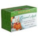 A box of Bigelow Caramel Apple Tea bags on a table with a Bigelow label.