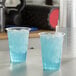 A glass of Gatorade Frost Glacier Freeze sports drink with ice on a counter.