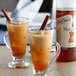 Two glasses of iced tea with cinnamon sticks and DaVinci Gourmet Cinnamon Bark syrup.