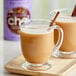A glass mug of brown David Rio Orca Spice Sugar-Free Chai Tea Latte with a cinnamon stick.